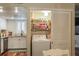 Laundry area features a washer, shelving, and is conveniently located near the kitchen at 102 Fairway Dr # 102, Longwood, FL 32779