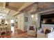 This cozy living room leads to the dining room, and features exposed wood beams at 102 Fairway Dr # 102, Longwood, FL 32779