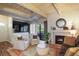 This cozy living room features exposed wood ceiling beams and a gas fireplace at 102 Fairway Dr # 102, Longwood, FL 32779