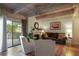 This cozy living room features exposed wood ceiling beams and a gas fireplace at 102 Fairway Dr # 102, Longwood, FL 32779
