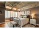 Charming bedroom features exposed wood beam ceiling, wood flooring, and large windows at 102 Fairway Dr # 102, Longwood, FL 32779