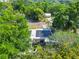 Aerial view of a home showcasing solar panels on the roof and lush green landscaping at 106 Alhambra Ave, Altamonte Springs, FL 32714
