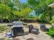 Spacious backyard featuring a grill, mature trees, and outdoor seating at 106 Alhambra Ave, Altamonte Springs, FL 32714
