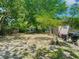 Wide view of the backyard with mature trees, grill and shed at 106 Alhambra Ave, Altamonte Springs, FL 32714