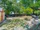 Large backyard area featuring mature trees, storage shed, and grill with seating at 106 Alhambra Ave, Altamonte Springs, FL 32714