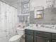 Bathroom with a grey wood-look accent wall and a shower with patterned curtain at 106 Alhambra Ave, Altamonte Springs, FL 32714