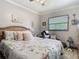 Inviting bedroom featuring a queen bed with floral comforter, a leather recliner, and soft, natural light at 106 Alhambra Ave, Altamonte Springs, FL 32714