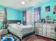 Bright bedroom with turquoise walls, neutral bedding, and a mirrored dresser at 106 Alhambra Ave, Altamonte Springs, FL 32714