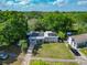 Charming single-story home with a well-manicured lawn and solar panels, nestled among mature trees at 106 Alhambra Ave, Altamonte Springs, FL 32714