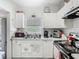Kitchen with white cabinets, marble countertops, stainless steel appliances, and window at 106 Alhambra Ave, Altamonte Springs, FL 32714
