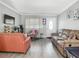 Cozy living room with comfortable furnishings, modern flooring, and a welcoming atmosphere, ideal for entertaining at 106 Alhambra Ave, Altamonte Springs, FL 32714