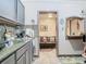 View from the kitchen into a living area with a black leather couch and accent lighting at 106 Alhambra Ave, Altamonte Springs, FL 32714