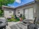 Outdoor patio area with grill, artificial turf, outdoor furniture, and a sliding glass door at 106 Alhambra Ave, Altamonte Springs, FL 32714