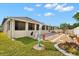 Backyard with extended patio, landscaping, and decorative lawn ornaments at 1199 Playa Del Sol Ln, St Cloud, FL 34771