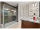 Modern bathroom featuring a large glass enclosed shower, granite countertops, and updated fixtures at 1199 Playa Del Sol Ln, St Cloud, FL 34771