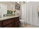 Bathroom features granite countertop, wooden cabinets, tile floors, and neutral walls at 1199 Playa Del Sol Ln, St Cloud, FL 34771