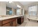 Bright bathroom with double vanity, granite countertops, large mirror and shower at 1199 Playa Del Sol Ln, St Cloud, FL 34771