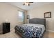 Comfortable bedroom features tile flooring, ceiling fan, and a patterned comforter at 1199 Playa Del Sol Ln, St Cloud, FL 34771