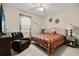 Cozy bedroom with tufted headboard, ceiling fan, and ample natural light at 1199 Playa Del Sol Ln, St Cloud, FL 34771
