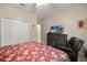 Comfortable bedroom with ceiling fan, TV, and large closet at 1199 Playa Del Sol Ln, St Cloud, FL 34771