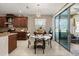 Cozy dining area with modern lighting, adjacent to the kitchen and sliding glass doors at 1199 Playa Del Sol Ln, St Cloud, FL 34771
