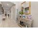 Inviting hallway featuring neutral walls, tile flooring, and a decorative console table at 1199 Playa Del Sol Ln, St Cloud, FL 34771