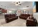 Inviting living room featuring tile floors, leather furniture, and an open layout at 1199 Playa Del Sol Ln, St Cloud, FL 34771