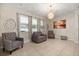 Bright living room with tile flooring, large windows and modern light fixture at 1199 Playa Del Sol Ln, St Cloud, FL 34771