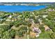 Stunning aerial view showing proximity to the gorgeous lake and surrounding mature trees at 12030 Kirby Smith Rd, Orlando, FL 32832
