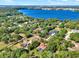 Breathtaking aerial shot showcasing lakeside homes nestled among trees with serene water views at 12030 Kirby Smith Rd, Orlando, FL 32832