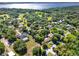 Picturesque aerial view of a lakeside neighborhood with lush greenery and spacious properties at 12030 Kirby Smith Rd, Orlando, FL 32832