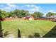 Well-maintained backyard with lush green grass, storage shed, and a sturdy wooden fence at 12030 Kirby Smith Rd, Orlando, FL 32832