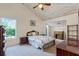 Bedroom featuring a ceiling fan, a window with an outside view and wooden furniture at 12030 Kirby Smith Rd, Orlando, FL 32832