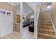 Inviting entryway with tile flooring and staircase leading up to the second floor at 12030 Kirby Smith Rd, Orlando, FL 32832