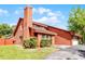 Charming two-story home features an attached garage, well-maintained lawn, and mature landscaping at 12030 Kirby Smith Rd, Orlando, FL 32832