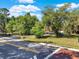 Landscaped front yard with mature trees providing shade and enhancing the curb appeal of this property at 12030 Kirby Smith Rd, Orlando, FL 32832