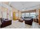 Cozy living room with tile floors, leather furniture, and natural light streaming through the windows at 12030 Kirby Smith Rd, Orlando, FL 32832