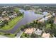 Aerial view of the neighborhood with large pond, mature trees, and beautiful single-Gathering homes at 131 Wimbledon Cir, Lake Mary, FL 32746
