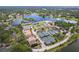 This aerial view showcases the community pool, multiple tennis courts, and lush landscaping around the lake at 131 Wimbledon Cir, Lake Mary, FL 32746