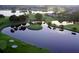 Aerial view showcasing a stunning golf course surrounded by serene lakes and beautiful homes at 131 Wimbledon Cir, Lake Mary, FL 32746
