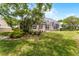 Backyard featuring a large screened patio and lush landscaping for privacy at 131 Wimbledon Cir, Lake Mary, FL 32746