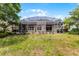 Backyard featuring a large screened patio and lush landscaping for privacy at 131 Wimbledon Cir, Lake Mary, FL 32746
