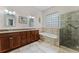 Bathroom featuring double sink vanity, soaking tub, and glass shower at 131 Wimbledon Cir, Lake Mary, FL 32746