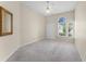 Inviting bedroom with a ceiling fan, closet with sliding doors and three large windows at 131 Wimbledon Cir, Lake Mary, FL 32746