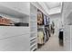 Spacious walk-in closet offers ample storage with custom shelving, drawers, and hanging racks at 131 Wimbledon Cir, Lake Mary, FL 32746