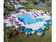 Aerial view of the community pool area featuring colorful umbrellas and plenty of seating in a tropical setting at 131 Wimbledon Cir, Lake Mary, FL 32746