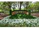 Well-maintained entrance to Heathrow with lush landscaping and colorful flowers at 131 Wimbledon Cir, Lake Mary, FL 32746