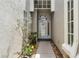 Inviting entryway with a glass front door, textured walls, and decorative plants at 131 Wimbledon Cir, Lake Mary, FL 32746