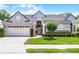Charming single-story home with a gray exterior, manicured lawn, and well-kept landscaping at 131 Wimbledon Cir, Lake Mary, FL 32746