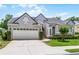 Well-maintained single-story home with a two-car garage, manicured lawn, and inviting curb appeal at 131 Wimbledon Cir, Lake Mary, FL 32746